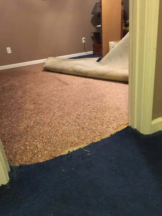 Carpet pad removal revealing water damage during Drying & Dehumidification in Hugo